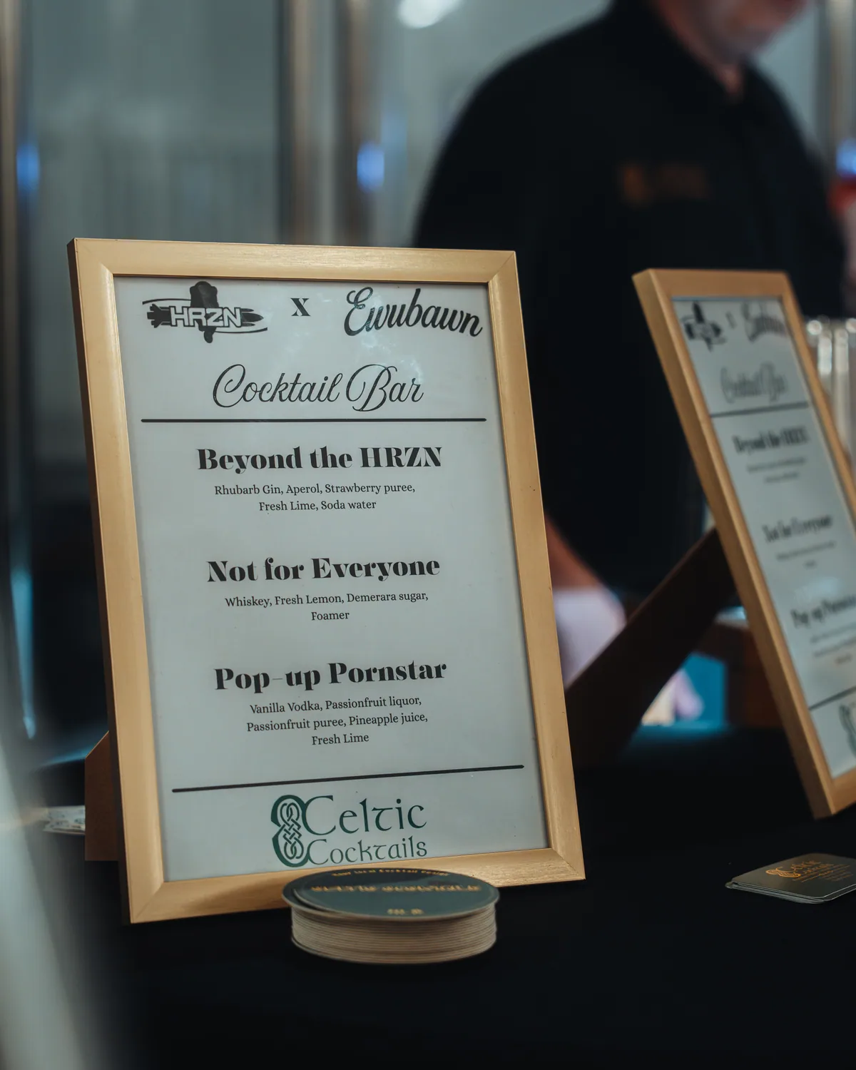 The printed cocktail menu on the bar