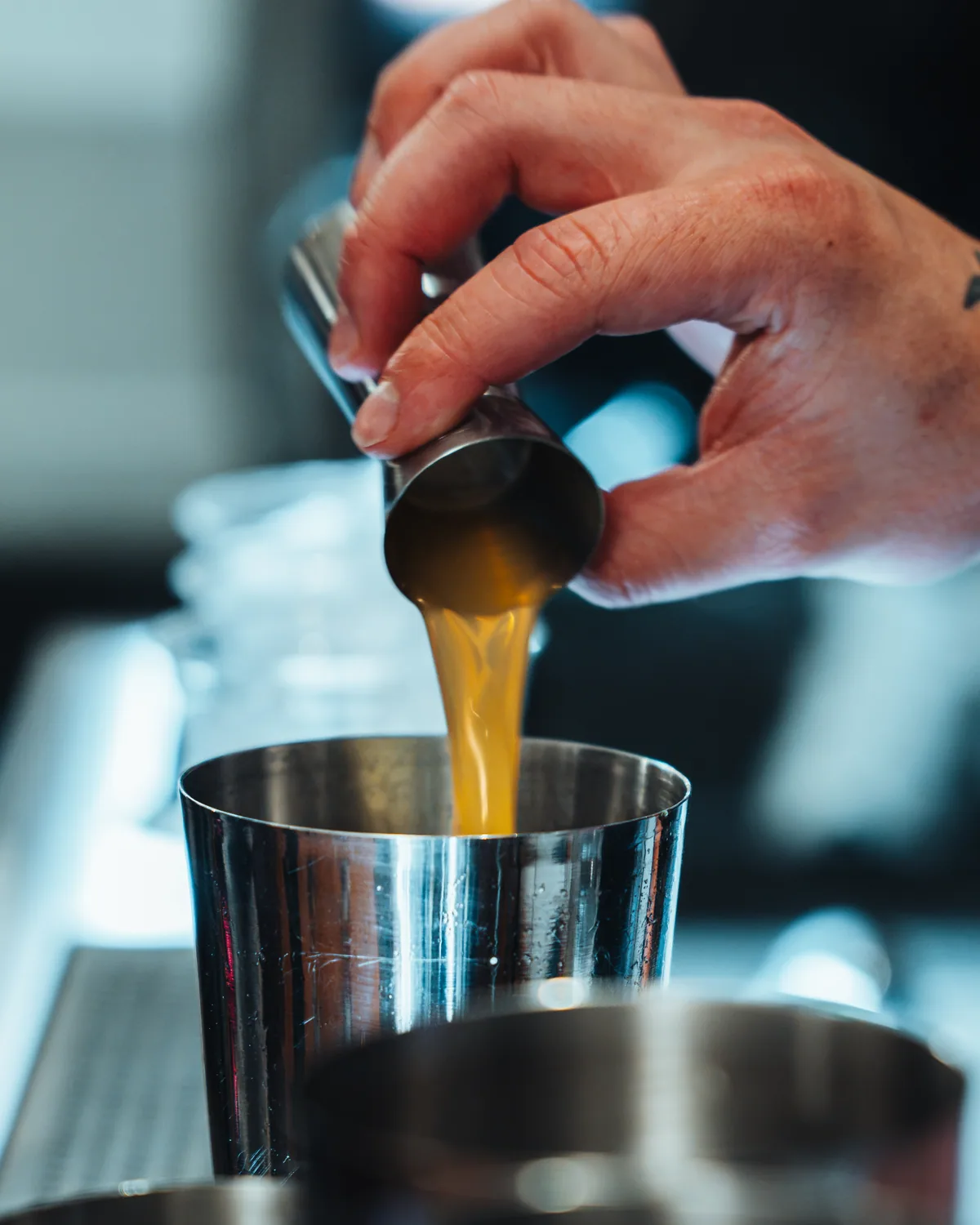 Pouring into the shaker behind the bar