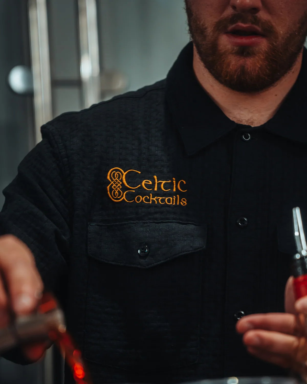 The Celtic Cocktails mark embroidered on the bar shirt